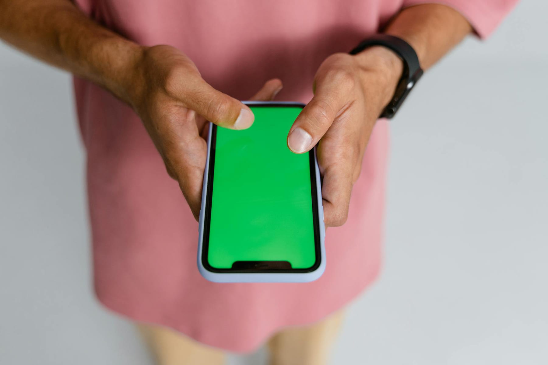Person holding smartphone with green screen for display mockup. on The Tech Shelf