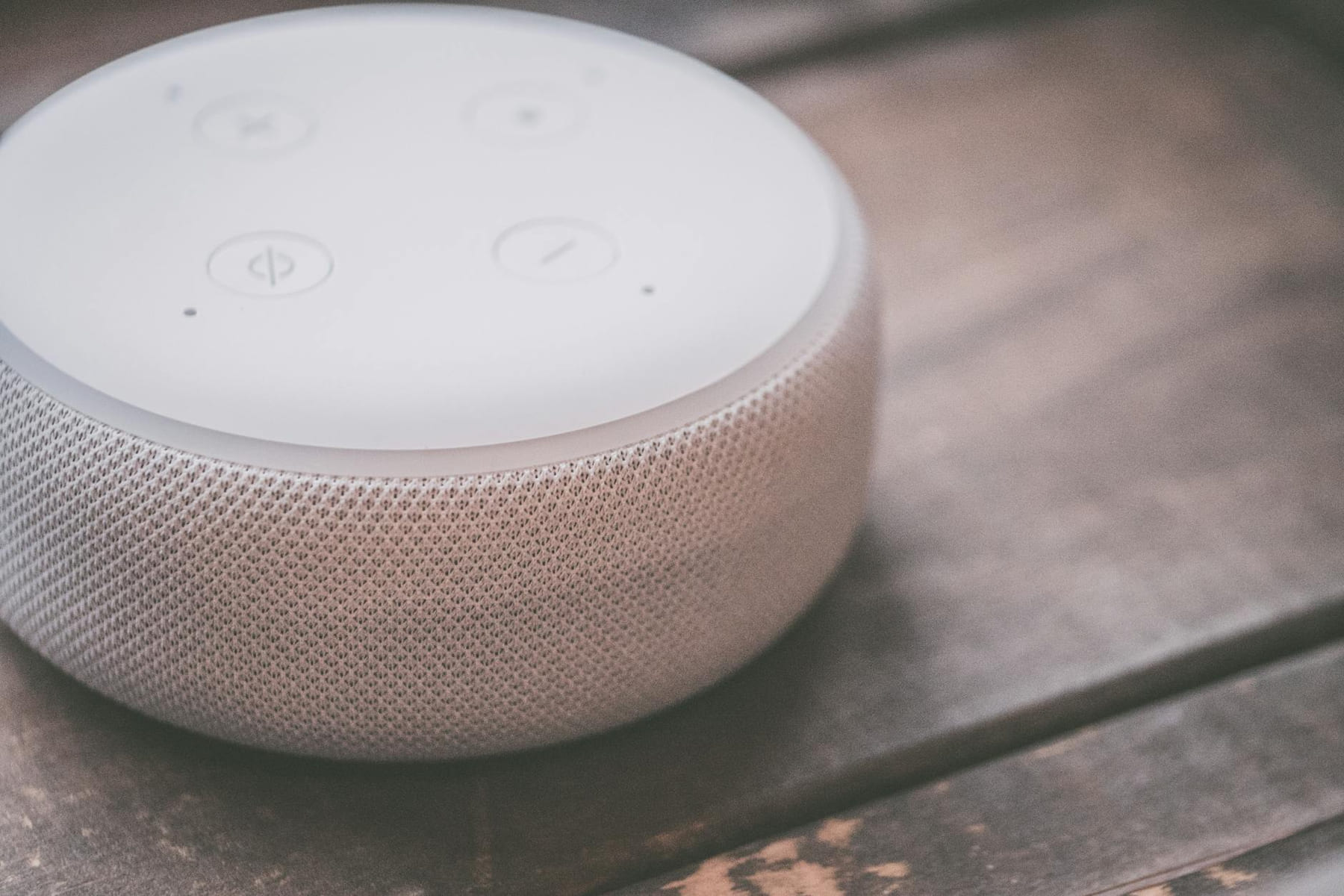 Close-up view of a smart speaker on a wooden surface, showcasing modern technology. on The Tech Shelf