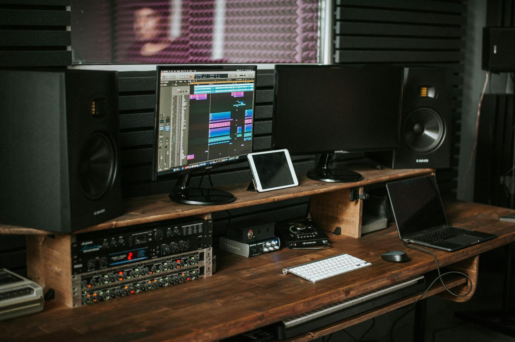 A modern music production workspace with monitors, speakers, and mixing equipment. on The Tech Shelf