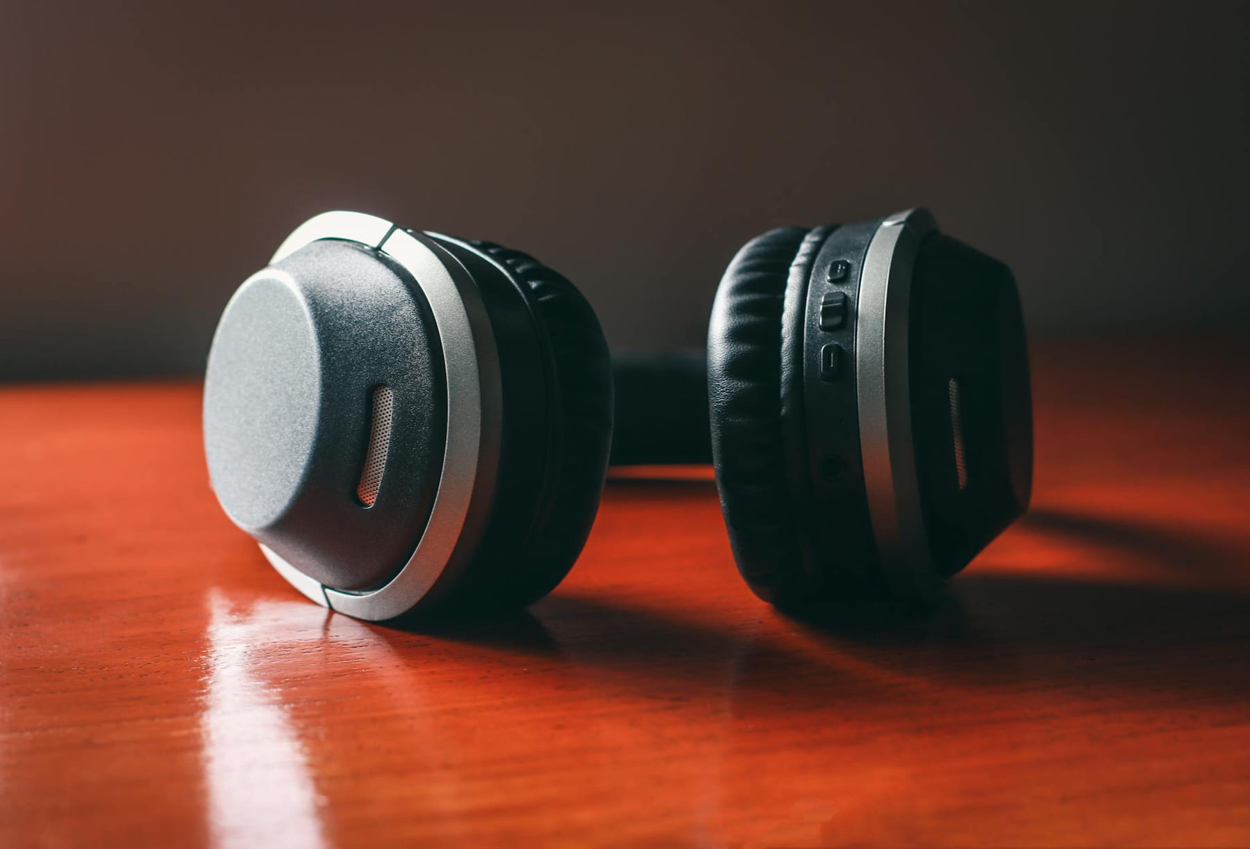 Close-up of wireless headphones on a wooden table, emphasizing design and technology. on The Tech Shelf
