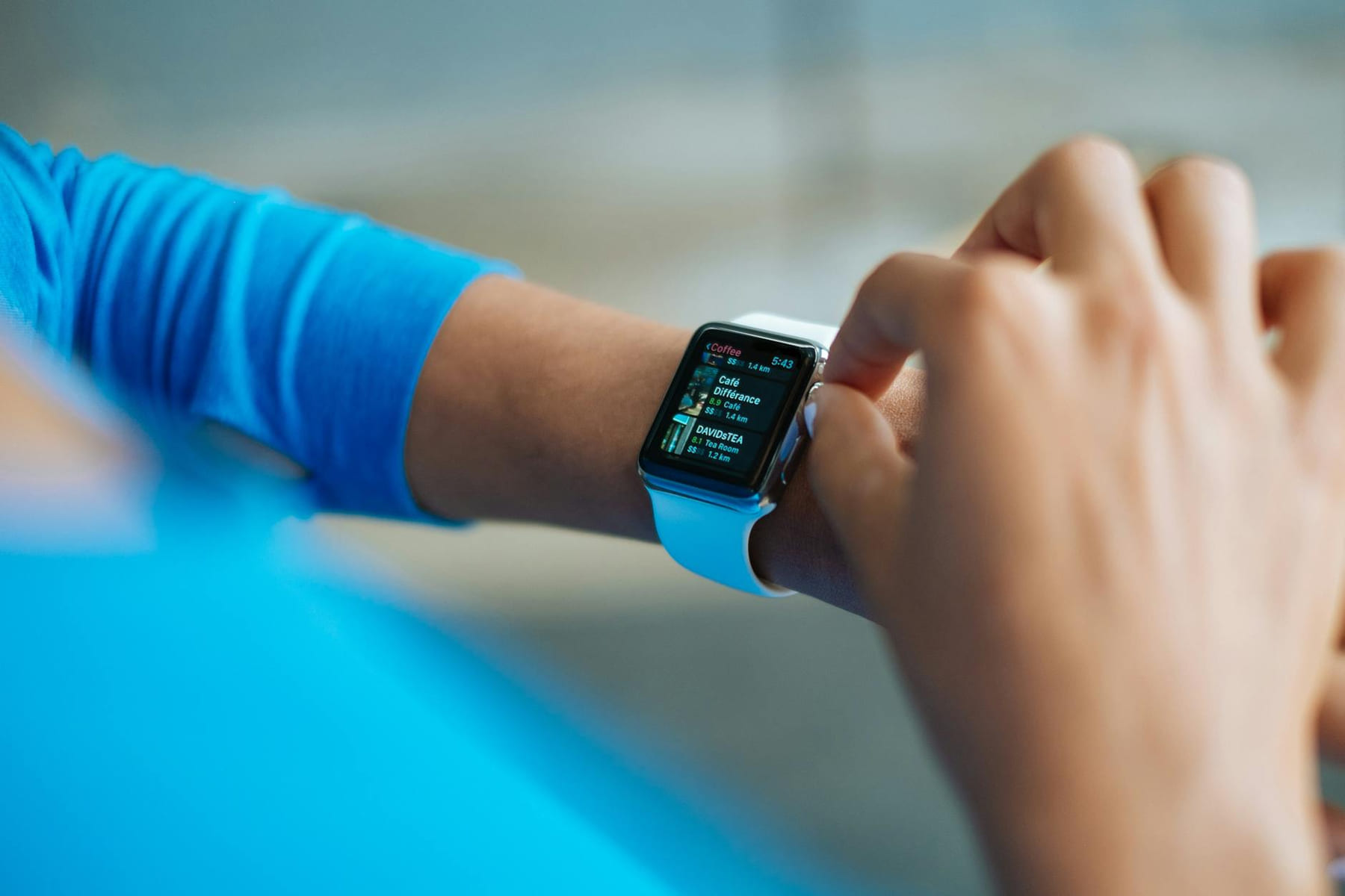 Person interacting with a smartwatch, showing a fitness application on the screen. on The Tech Shelf