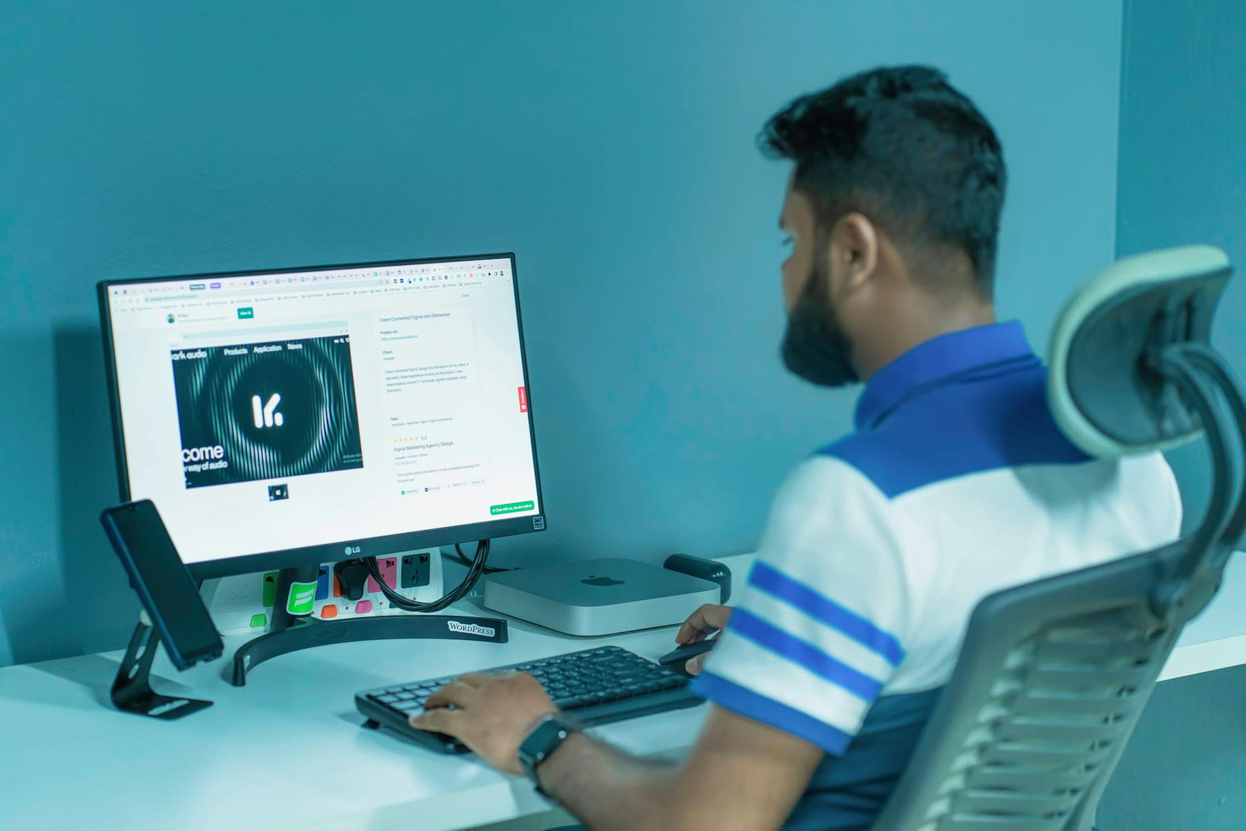 Man using a desktop computer with modern tech setup in a professional office environment. on The Tech Shelf