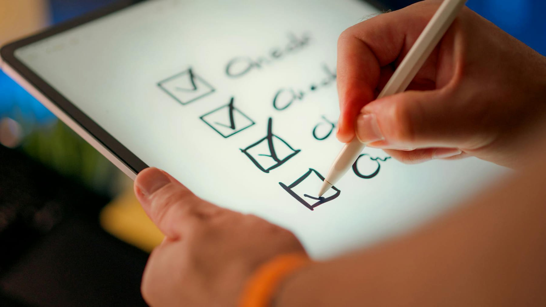 Close-up of a digital checklist being marked off on a tablet with a stylus pen. on The Tech Shelf