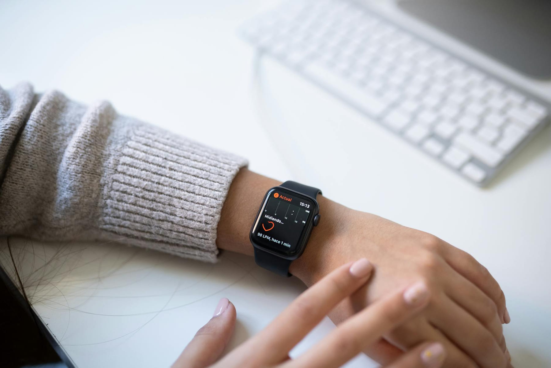 Close-up of a person checking health stats on a smartwatch in an office environment. on The Tech Shelf